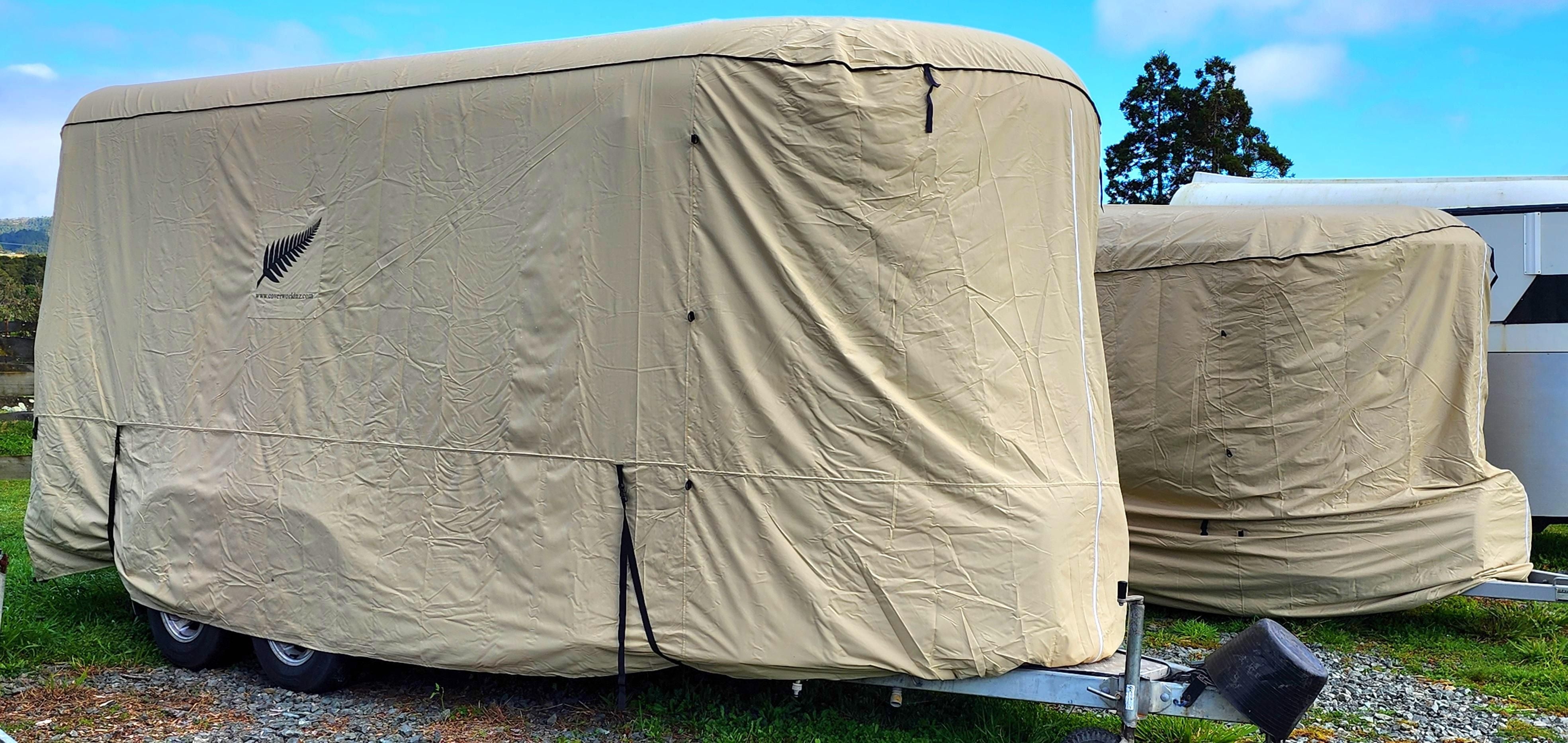 image of a horse float covered by a beige rounded front horse float premium cover