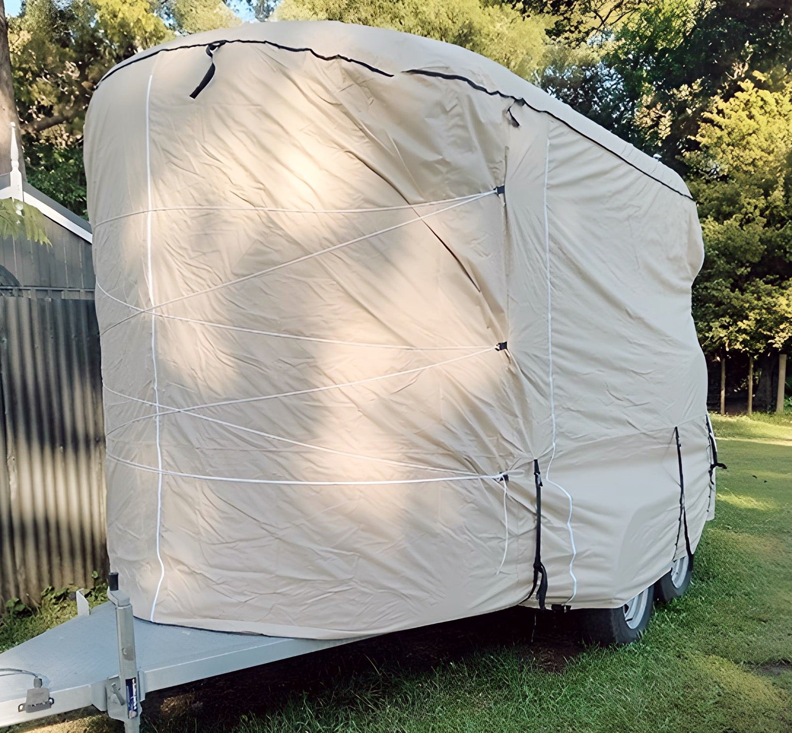 image of a horse float covered by a beige rounded front horse float premium cover
