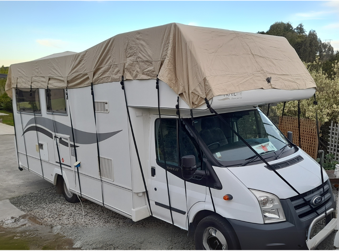 Image of motorhome with roof cover on tp protect from leaves, rain and debirs.