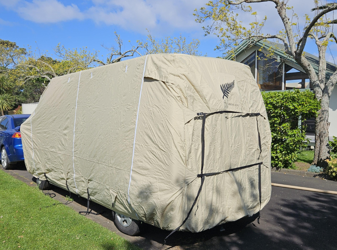 Image of back of motorhome with beige cover showing the straps to secure the cover